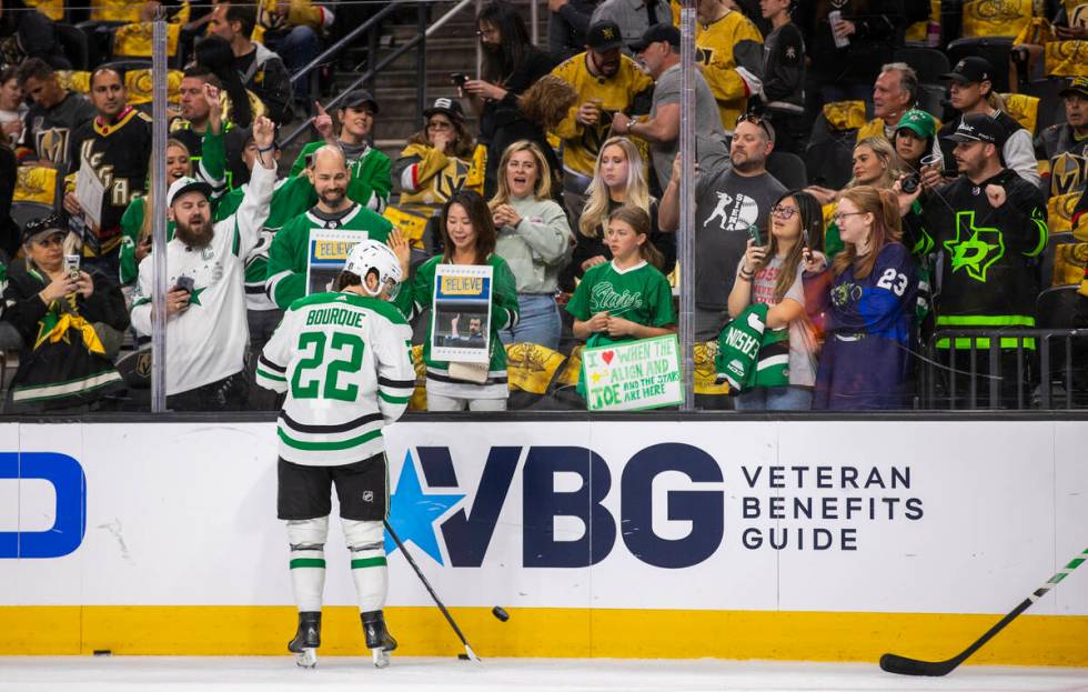 Dallas Stars center Mavrik Bourque (22) flicks up a puck to toss to the fans during warm ups in ...