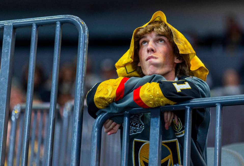 A Golden Knights fan watches the clock tick down as the Dallas Stars are up two scores during t ...