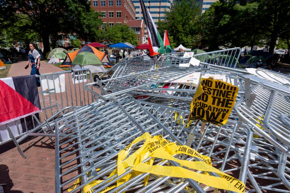 Barricades torn down by demonstrators are piled in the center of an encampment by students prot ...