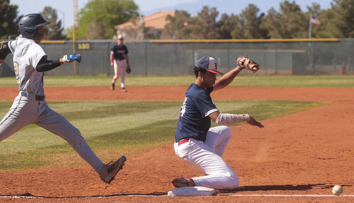 Liberty’s Shawn Mack (24) misses the catch as Spring Valley's Royce Ogawa (22) makes it ...