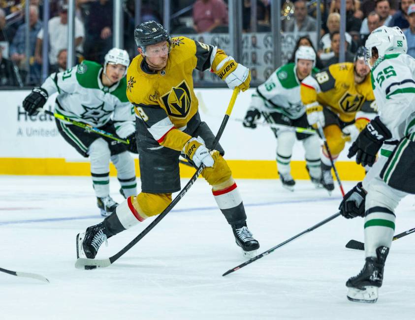 Golden Knights center Jack Eichel (9) winds up for a shot on goal past Dallas Stars defenseman ...