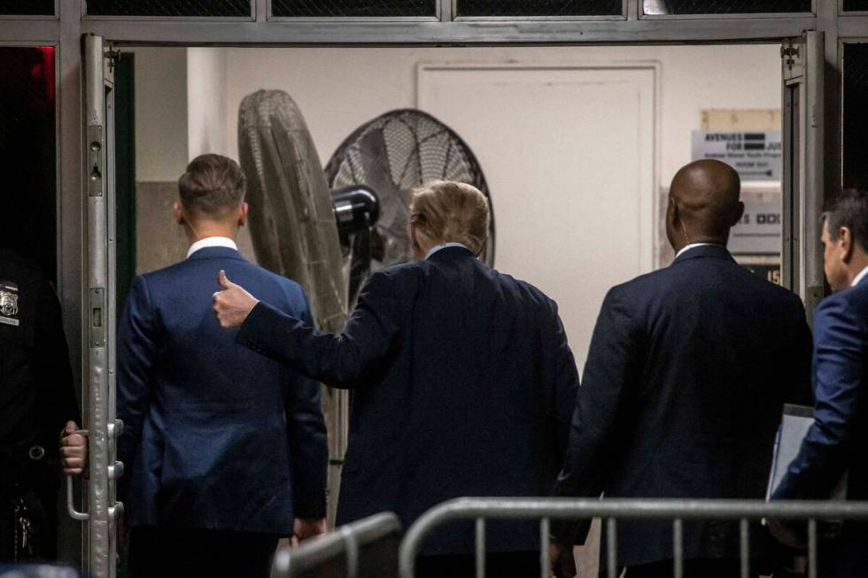 Former President Donald Trump gestures as he leaves the courtroom during a break in his trial M ...