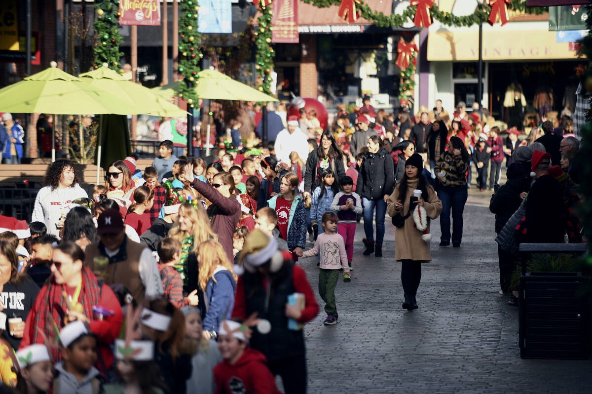 Visitors take part in the annual Donation Day Parade in Grass Valley, Calif., Dec. 21, 2023. On ...