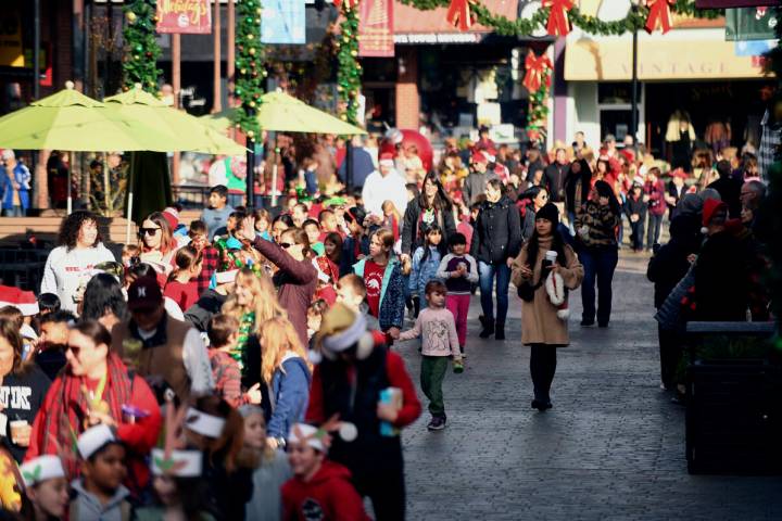 Visitors take part in the annual Donation Day Parade in Grass Valley, Calif., Dec. 21, 2023. On ...