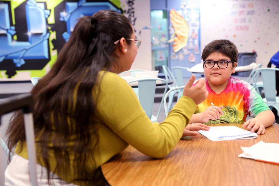 Jerania Mancilla, assistant teacher for resource room, works with fourth-grader Daniel Gomez Ro ...