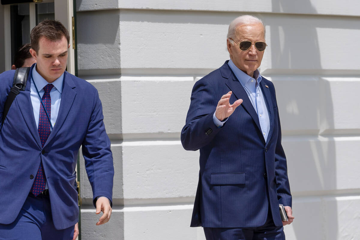 President Joe Biden waves as he walks to Marine One for departure from the South Lawn of the Wh ...