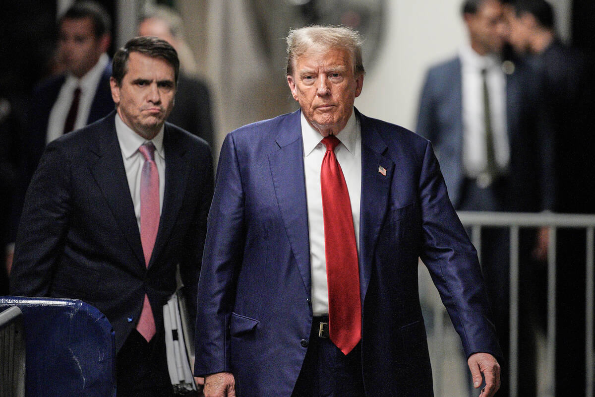 Former President Donald Trump walks outside the courtroom of his trial at Manhattan criminal co ...