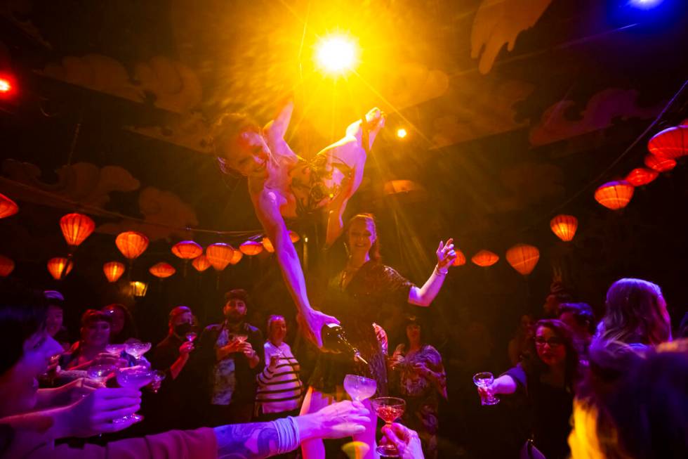 Head distiller Mary Dempsey, who is also an aerialist, pours rum for guests during the closing ...