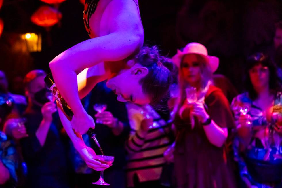 Head distiller Mary Dempsey, who is also an aerialist, pours rum for guests during the closing ...