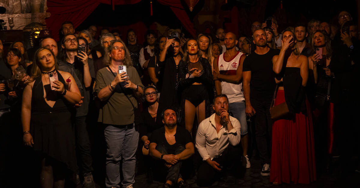 Guests and cast members watch as aerialist Pawel Walczewski performs his final act during the c ...