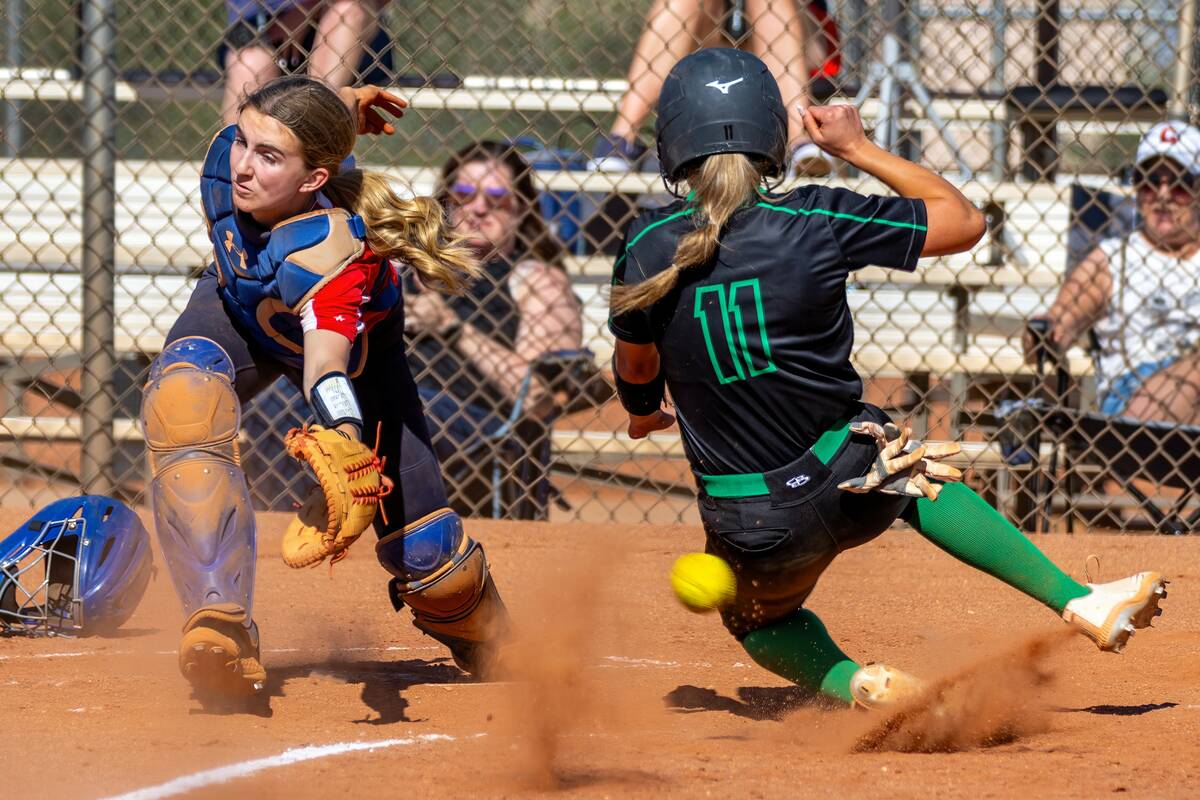 Coronado catcher Mary Lou Tsunis (10) is unable to grab a short throw as Palo Verde runner Tayl ...