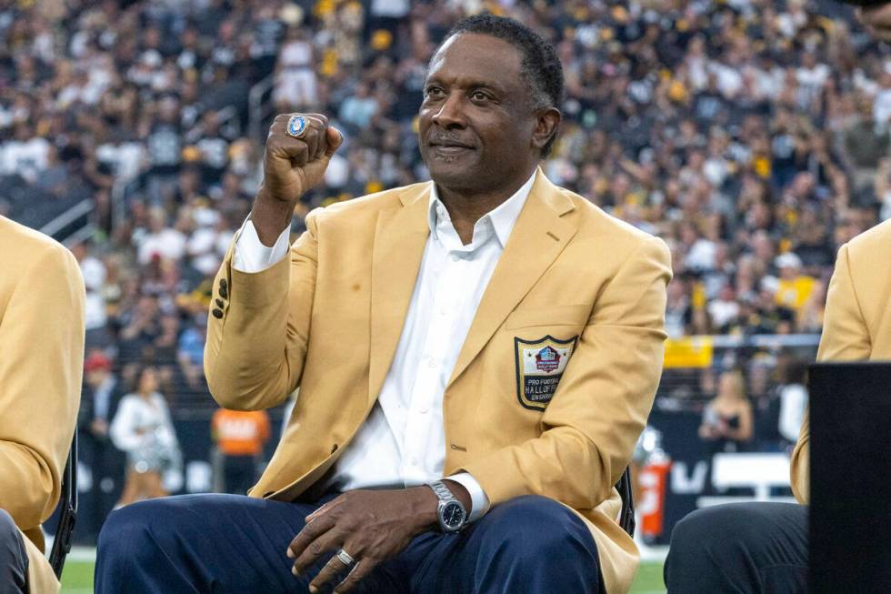 Raiders Hall of Famer Tim Brown pumps his fist on the field as he is introduced during ring cer ...