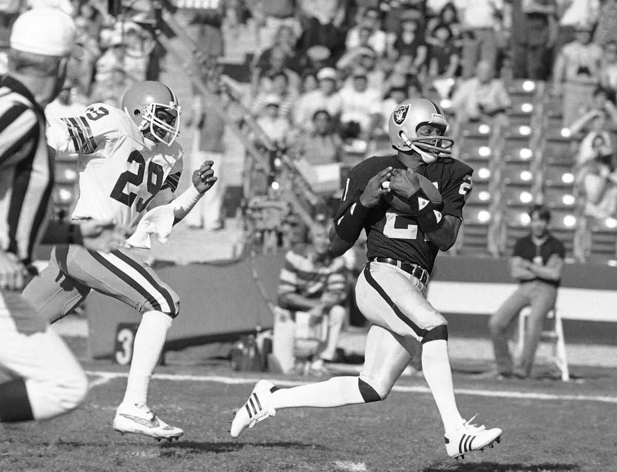 In this Saturday, Jan. 8, 1983 file photo, Los Angeles Raiders wide receiver Cliff Branch, righ ...