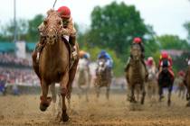 Rich Strike, with Sonny Leon aboard, wins the 148th running of the Kentucky Derby horse race at ...