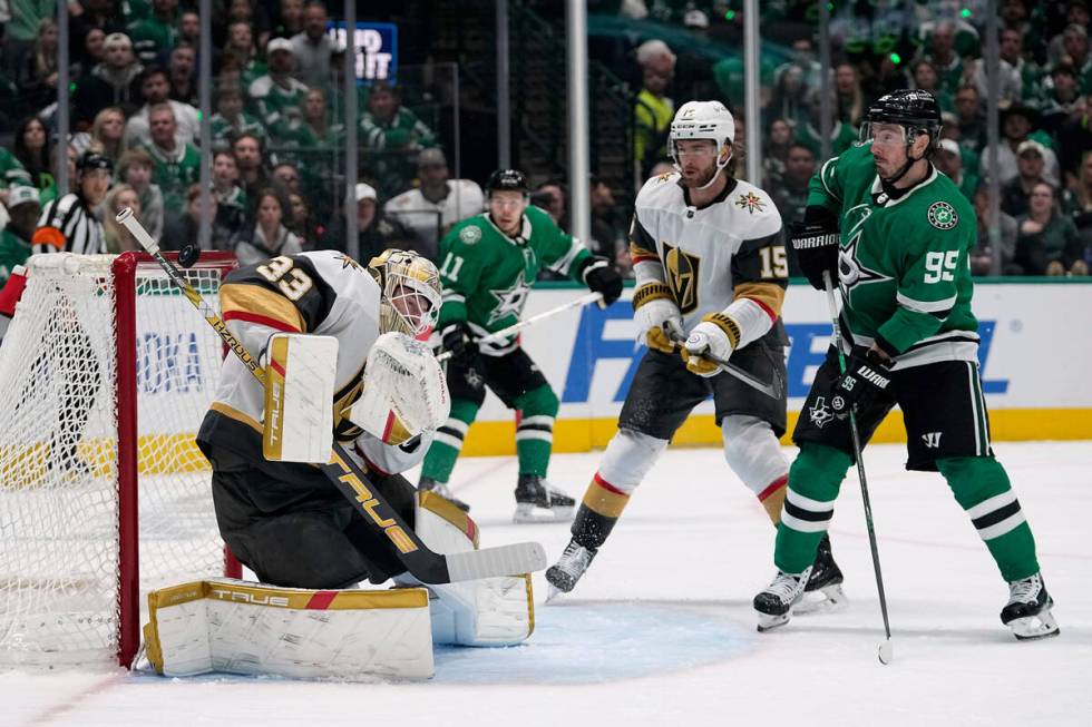 Vegas Golden Knights goaltender Adin Hill (33) uses his shoulder to deflect a shot as Pavel Dor ...