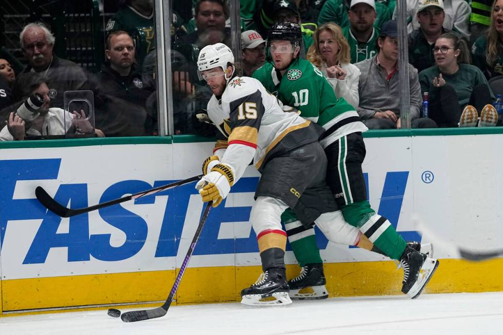 Vegas Golden Knights defenseman Noah Hanifin (15) and Dallas Stars' Ty Dellandrea (10) compete ...