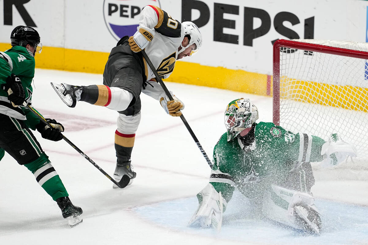 Dallas Stars goaltender Jake Oettinger (29) uses his right leg to block a shot by Vegas Golden ...