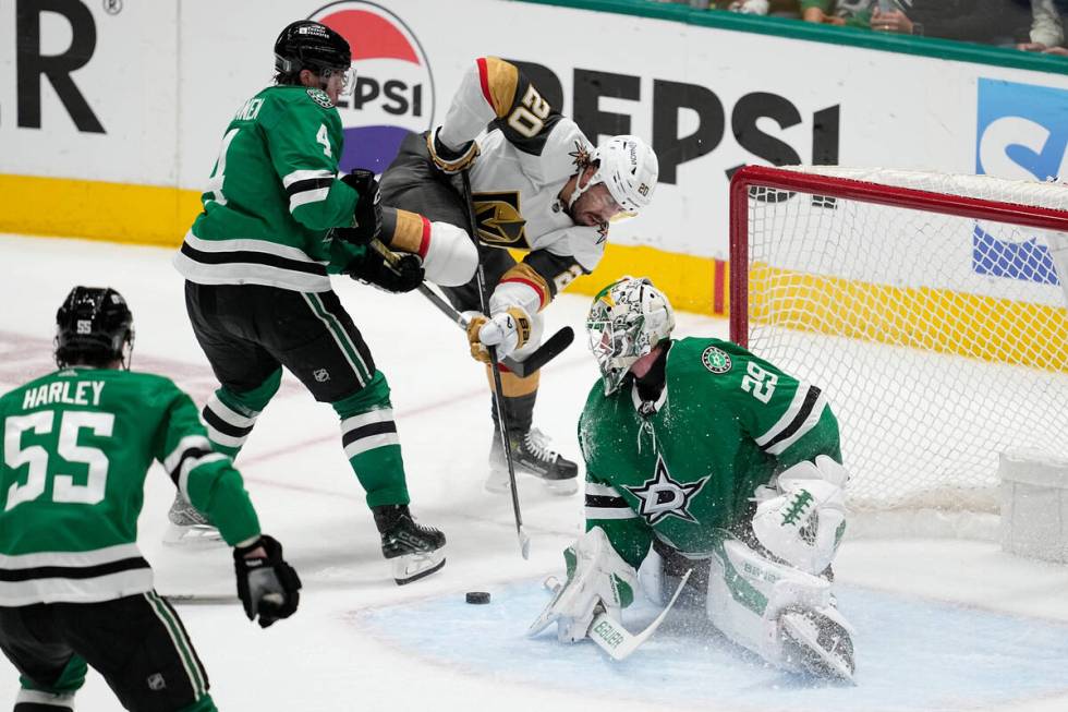 Dallas Stars goaltender Jake Oettinger (29) and Miro Heiskanen (4) defend against a shot by Veg ...