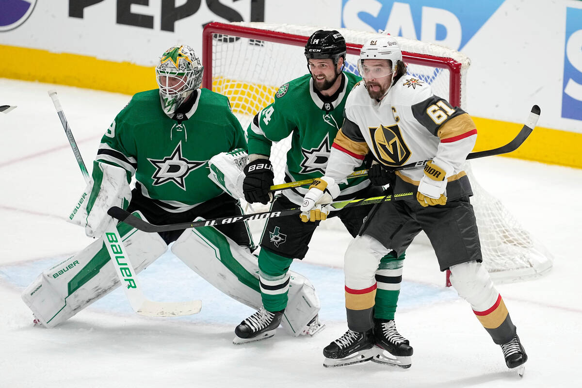 Dallas Stars goaltender Jake Oettinger, left, and left wing Jamie Benn (1) defend the net again ...