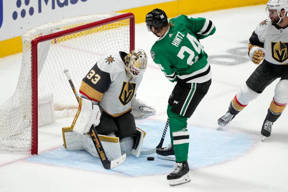 Vegas Golden Knights goaltender Adin Hill (33) blocks a shot by Dallas Stars' Roope Hintz (24) ...