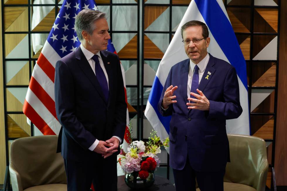 U.S. Secretary of State Antony Blinken, left, and Israeli President Isaac Herzog talk during th ...