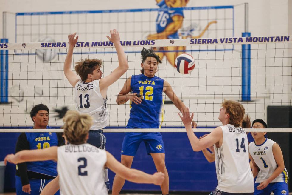 Sierra Vista middle blocker Lance Param (12) hits the ball over the net during a boys volleybal ...