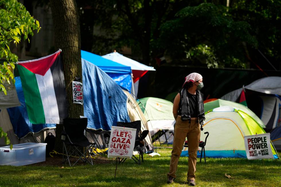 A person stands at a Gaza Solidarity Encampment at the University of Pennsylvania in Philadelph ...