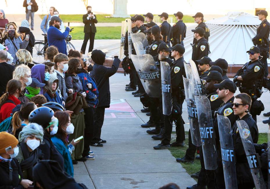 Protesters against the war in Gaza confront law enforcement personnel during demonstrations on ...