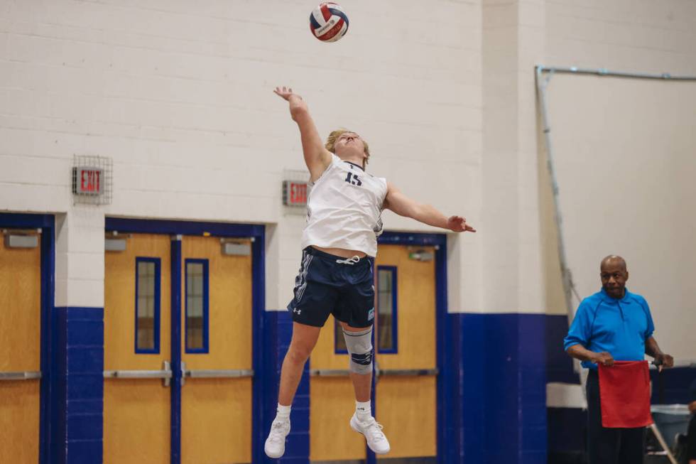 Centennial outside hitter Austin Randolph (15) serves the ball during a boys volleyball game be ...