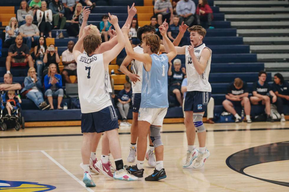 Centennial players celebrate an ace during a boys volleyball game between Centennial and Sierra ...