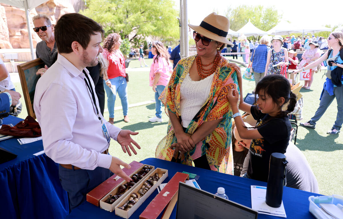 Joen and her son Luke, 8, of Long Beach, Calif. talk to expert Tim Andreadis about their Hector ...