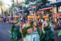 Members of the Nani Ola Hawaiian Dance Company greet guests during the Lei Day Parade, a celebr ...