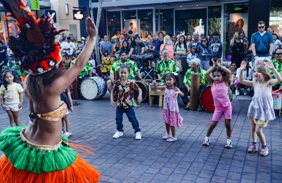 Performer Leina’ala Cardona, with Hot Lava Productions, shows kids how to dance during the Le ...