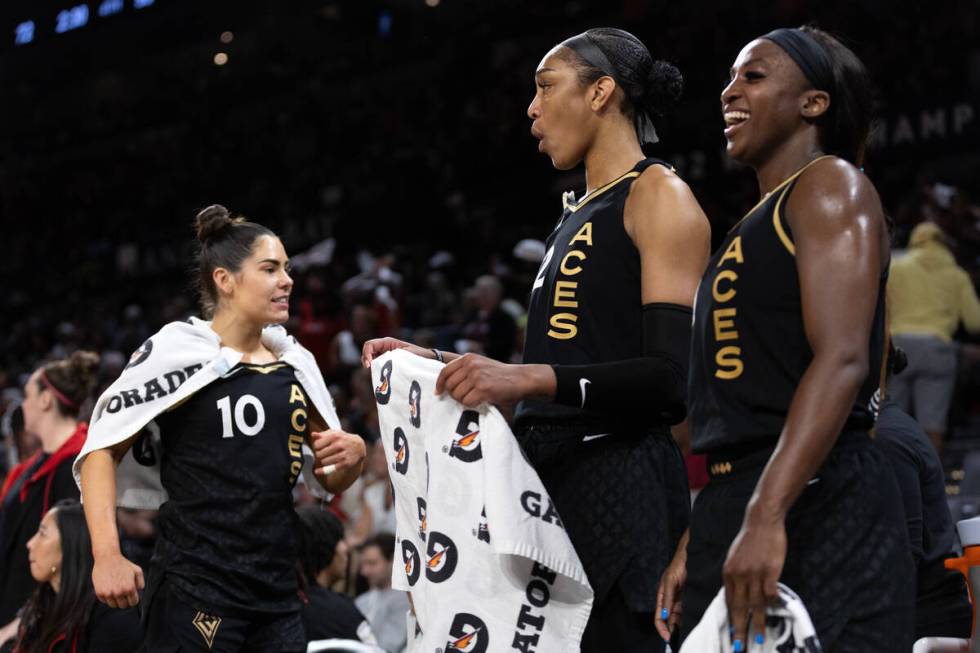 Las Vegas Aces guard Kelsey Plum (10), forward A'ja Wilson, center, and guard Jackie Young reac ...