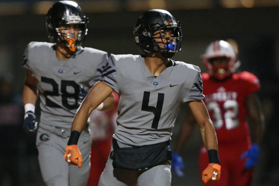 Bishop Gorman Rome Odunze (4) celebrates a touchdown catch, with Izaiah Halmos (28), in the fir ...