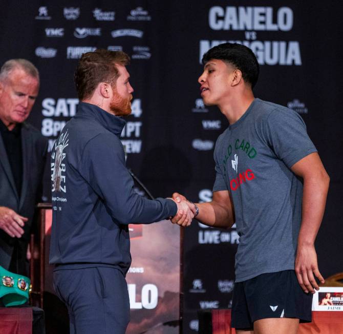 Boxer Canelo Alvarez shakes hands with opponent Jaime Munguia during the final press conference ...