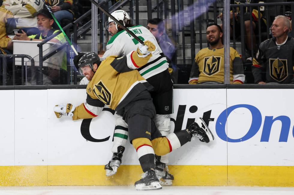 Golden Knights right wing Jonathan Marchessault (81) checks Stars defenseman Chris Tanev (3) in ...