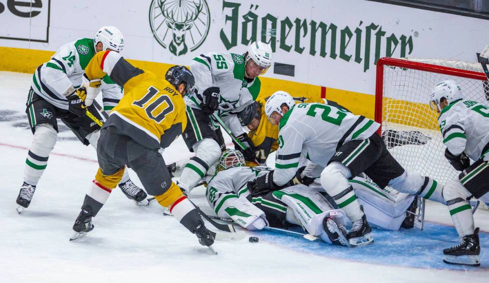 Dallas Stars goaltender Jake Oettinger (29) is on the ice as Golden Knights center Nicolas Roy ...