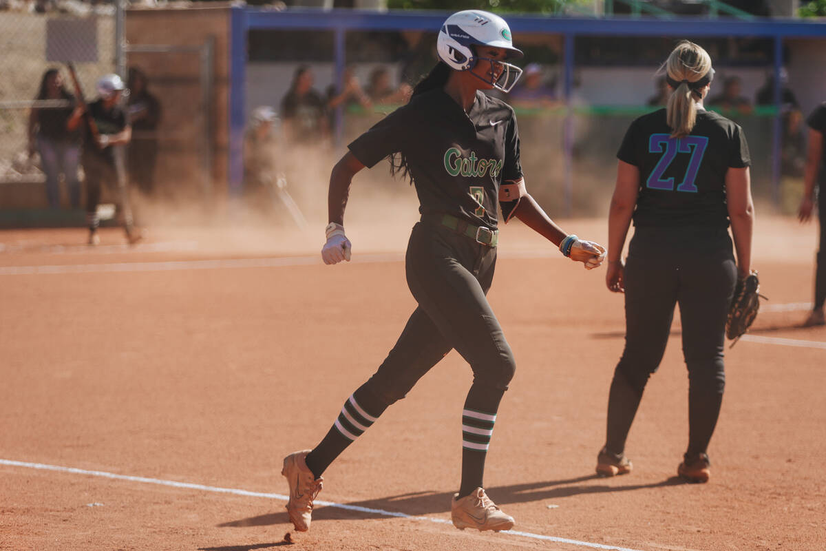 Green valley’s Gabrielle Machida (7) smiles as she reaches first base during a softball ...