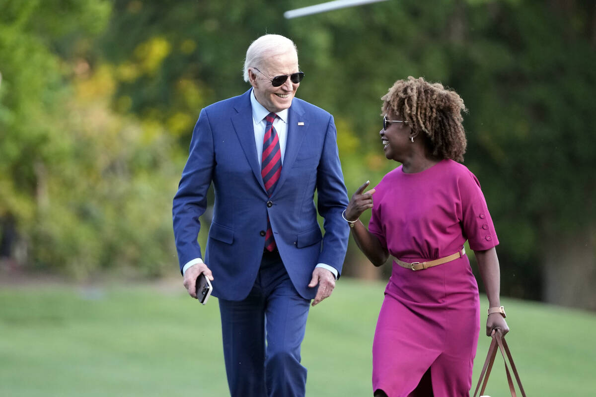 President Joe Biden walks across the South Lawn of the White House as he talks with White House ...