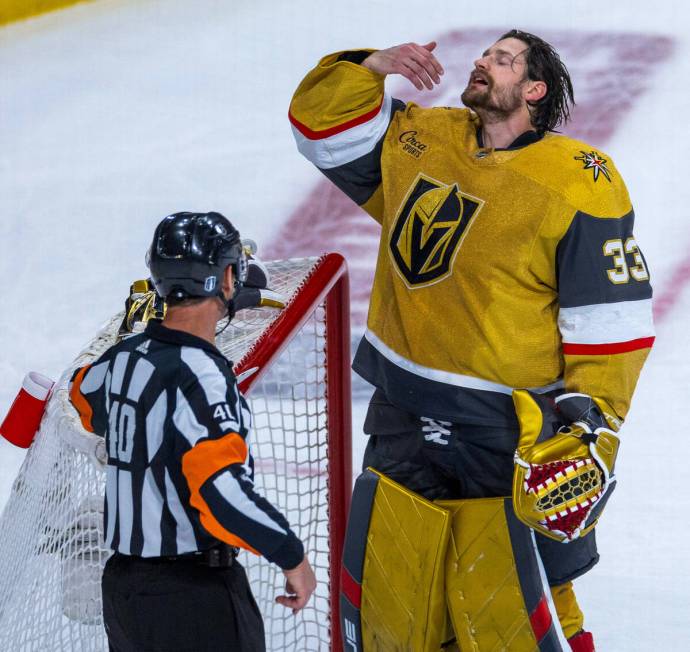 Golden Knights goaltender Adin Hill (33) is upset about a stick hold by the Dallas Stars during ...