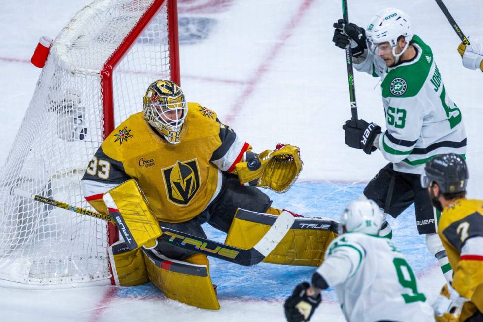 Golden Knights goaltender Adin Hill (33) makes save close to Dallas Stars center Wyatt Johnston ...