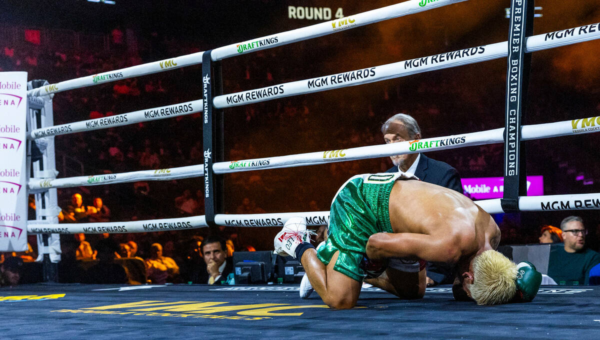 Featherweight Jessie Magdaleno is down due to a low blow by Brandon Figueroa during the fourth ...