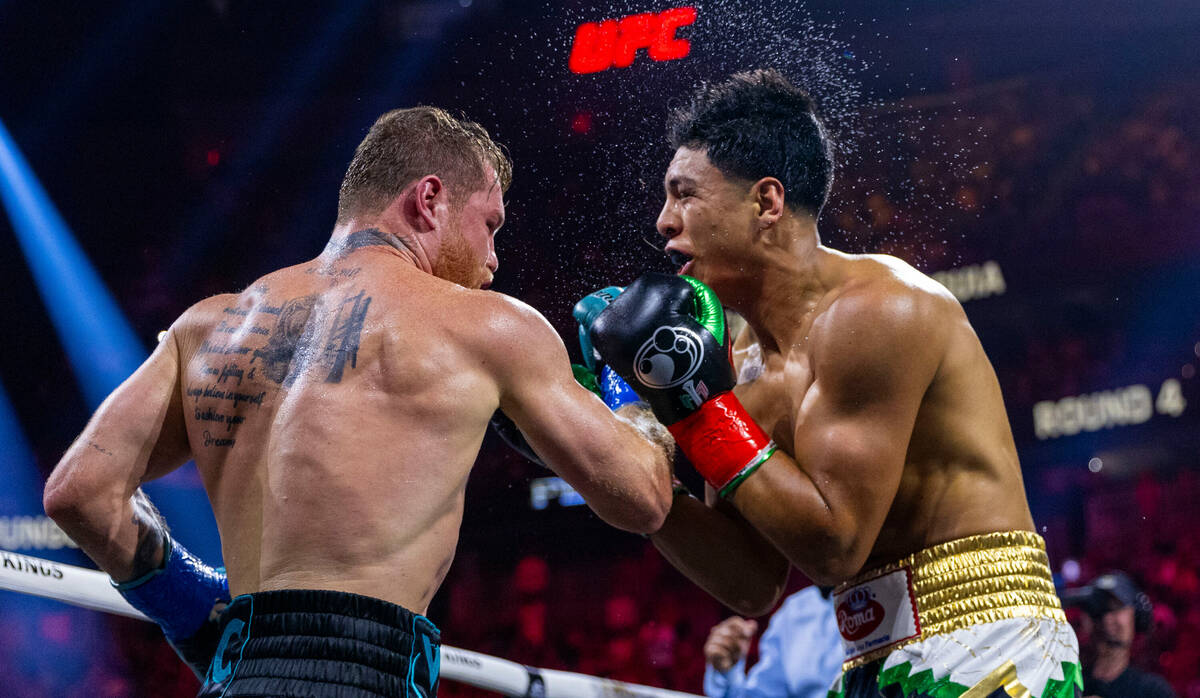 Canelo Alvarez connects with a punch to the chin of Jaime Munguia during the third round of the ...