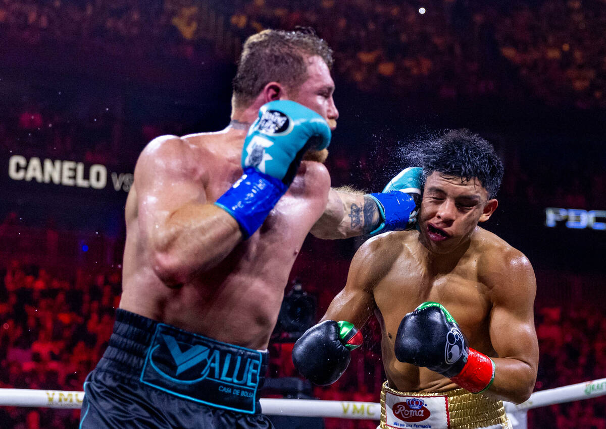 Canelo Alvarez connects with a punch to the side of the head of Jaime Munguia during the sixth ...