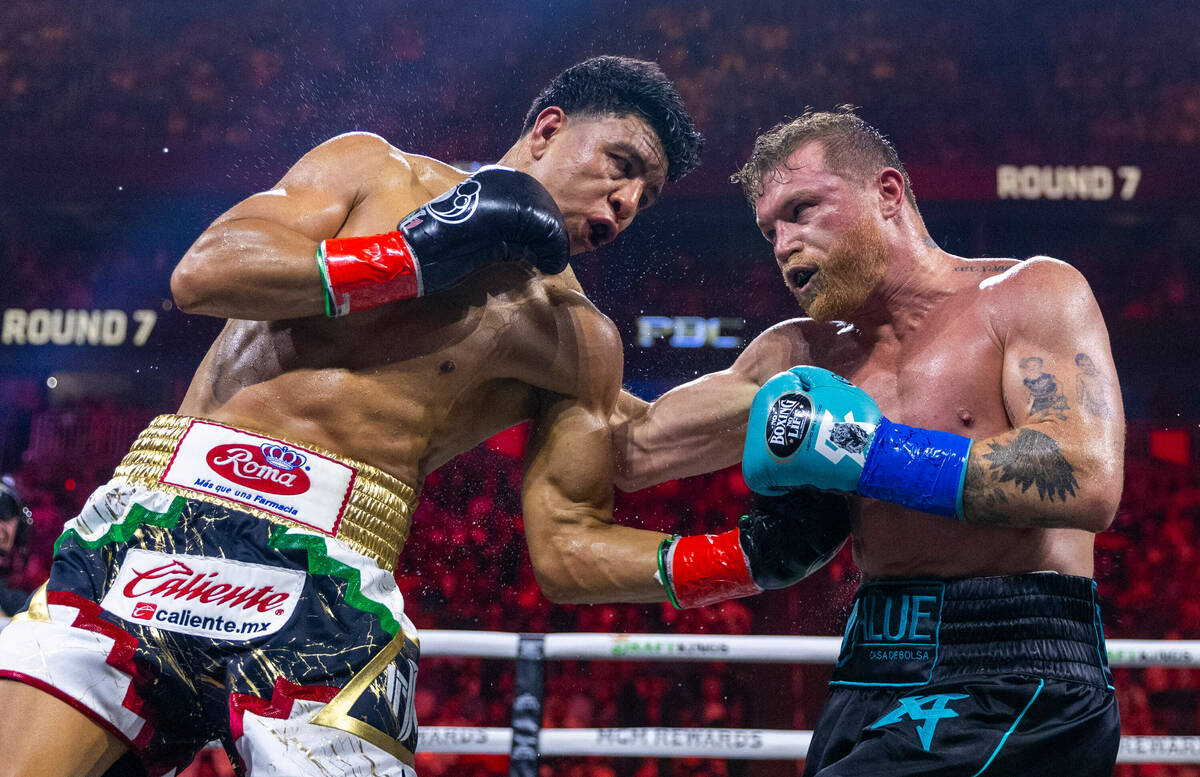 Jaime Munguia and Canelo Alvarez trade punches during the seventh round of their PPV boxing nig ...