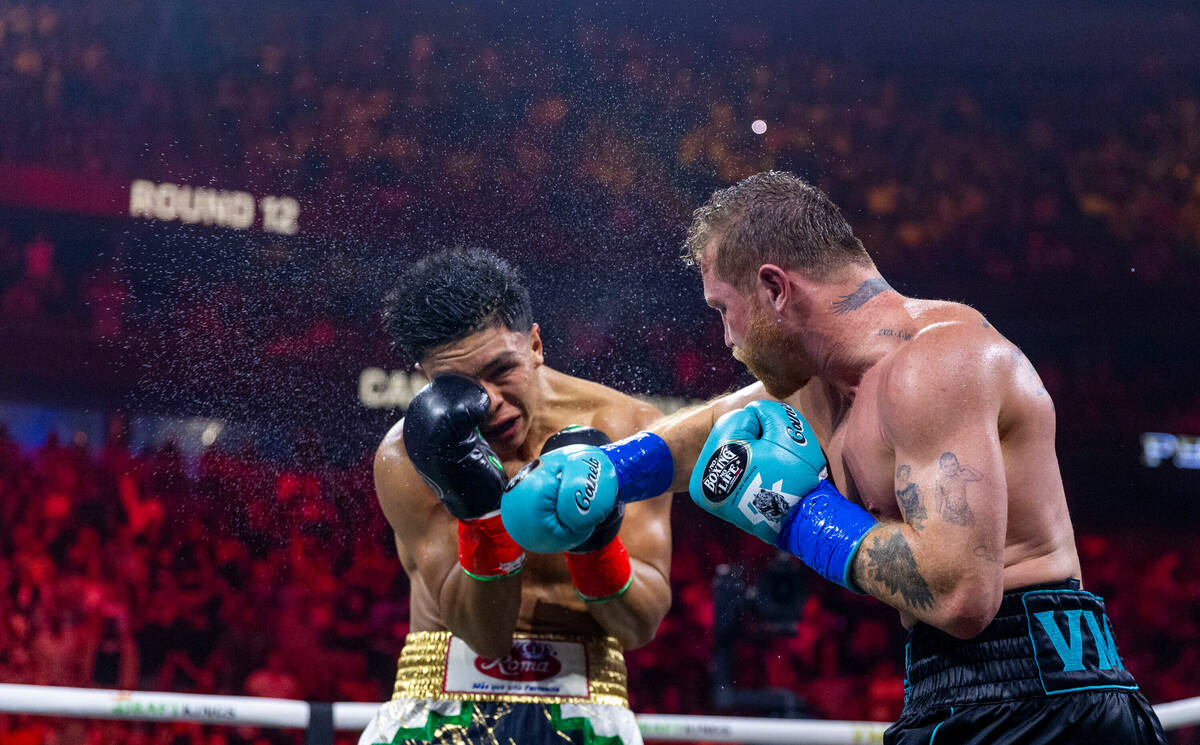 Jaime Munguia takes a shot to the chin from Canelo Alvarez during the twelfth round of their P ...