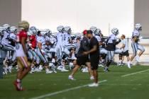 Raiders defensive end Maxx Crosby (98) leads the team in warmups during training camp before sc ...