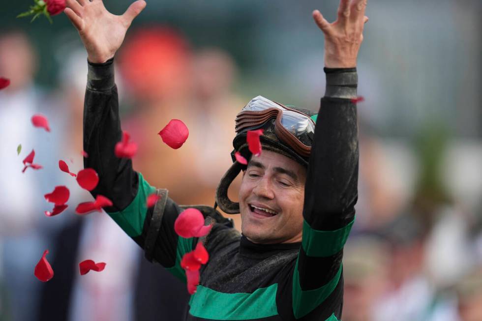 Brian Hernandez Jr. celebrates in the winner's circle after riding Mystik Dan to win the 150th ...