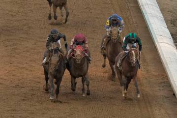 Brian Hernandez Jr. rides Mystik Dan, right, across the finish line to win the 150th running of ...